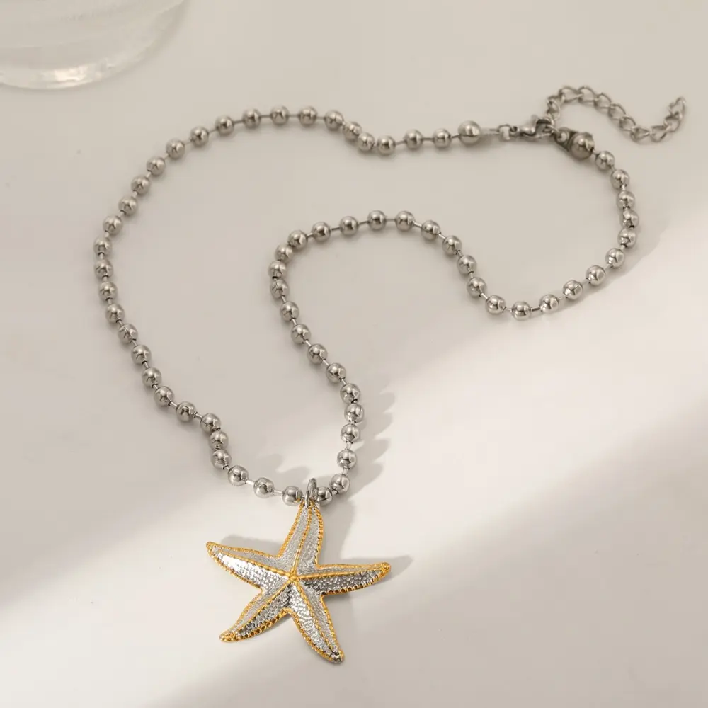 Estrella de mar plateada con dije bicolor
